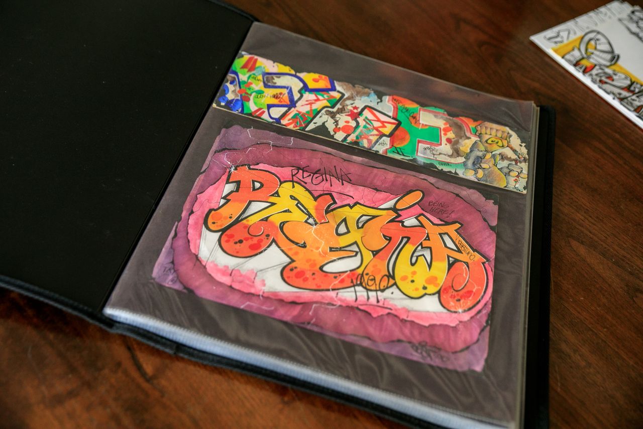 The Art of Drawing Readers In: Your attractive post title goes here Vibrant graffiti art showcased in a sketchbook on a wooden table, perfect for art enthusiasts.