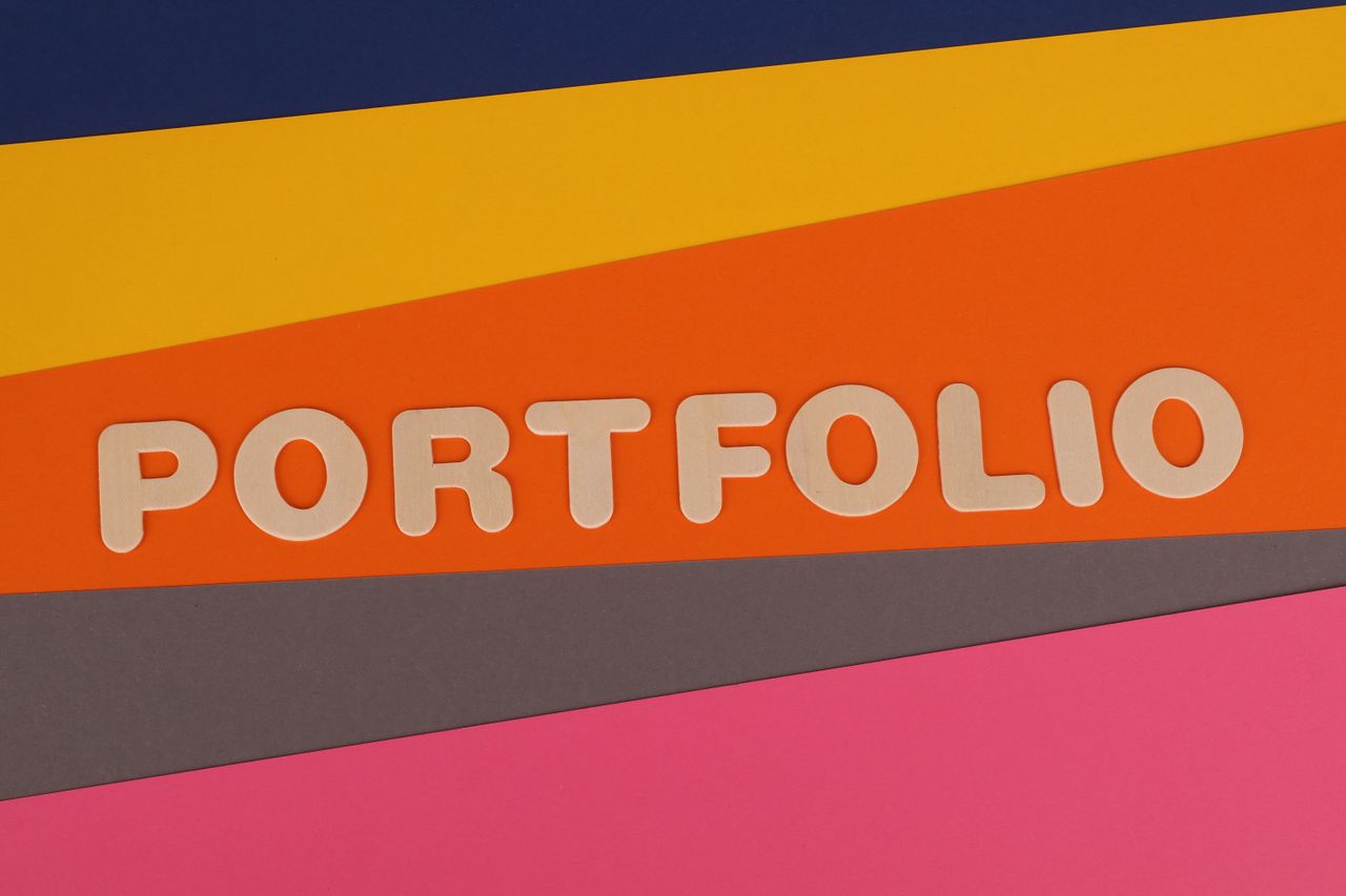 Crafting Captivating Headlines: Your awesome post title goes here A vibrant multicolored background featuring the text 'PORTFOLIO' in pink font on colorful paper.